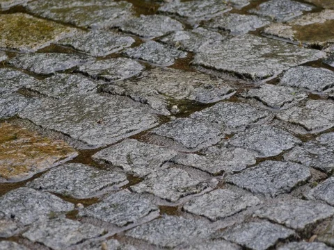Street with Cobblestones in the rain Stock Footage 75387986