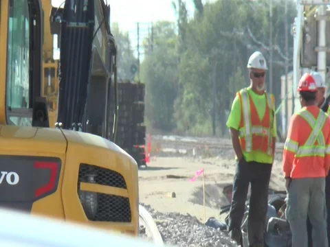 Street Construction Workers Talk as Traffic Passes 스톡 동영상 81180483