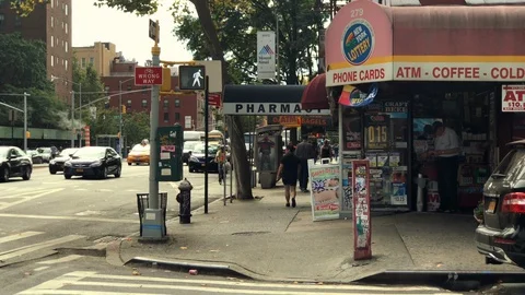Street corner convenience store deli grocery ATM phone cards New York City NYC Stock Footage