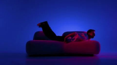 Street dance pose beside modern sofa Stock Footage 345602122