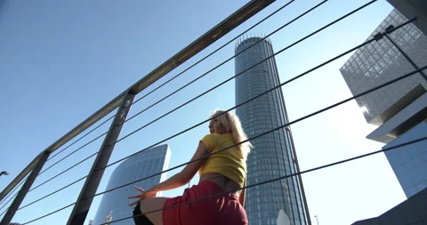 Street dancer dancing on the background of a business center Stock Footage 146838178