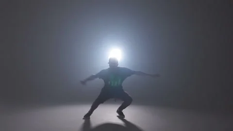 Street dancer performing different moves on the dark street, slow motion Stock Footage 105395676