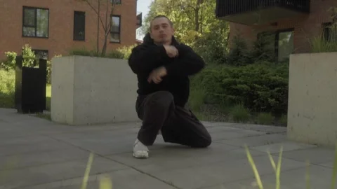 Street dancer performs dynamic breakdance moves, showcasing strength and agility Stock Footage 283489666