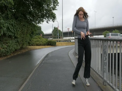 Street Dancing and Walking on a Bridge Sidewalk Stock Footage