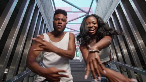 Street Dancing. Young Couple Dancing On The Stairs. Cheerful Black Guy And Girl Stock Footage 142087953