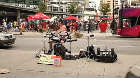 A street drummer playing a drum set ,near Dundas square in Toronto, Canada Stock Footage 245594089
