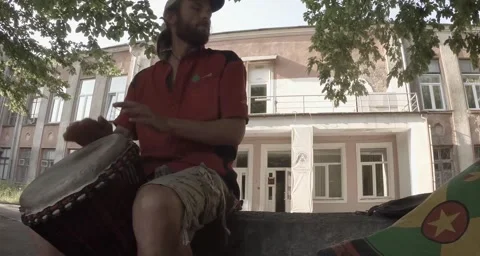 Street drummer plays hands on a makeshift drum Stock Footage 50454852