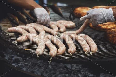 Street fast food, grilled sausages at bbq Stock Photos