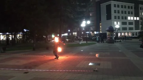 Street fire show. A man controls burning torches on a city street. Street life Stock Footage 198431226
