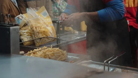 Street food joint serving fried french fries Stock Footage