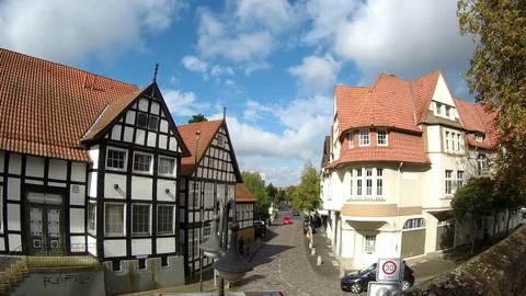 A street in Germany. There are two cars passing by. Stock Footage 80048932