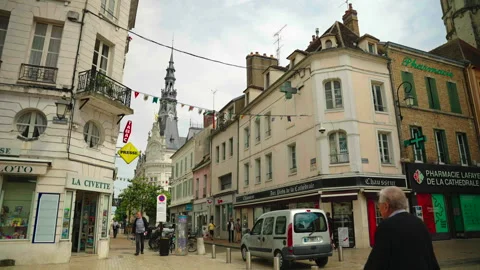 Street intersection with shops and town hall, Sens, France Видео 339201323
