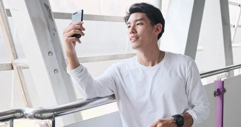 Street kid face time using mobile phone in overpass. Asian man in white shirt. Stock Footage 106382535