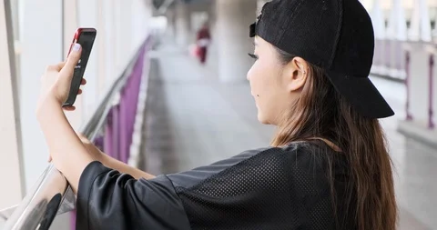 Street kid face time using mobile phone with his boyfriend in overpass with Stock Footage 106382968