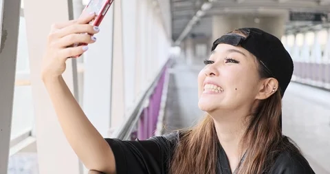 Street kid face time using mobile phone with his boyfriend in overpass, happy Stock Footage 106383170