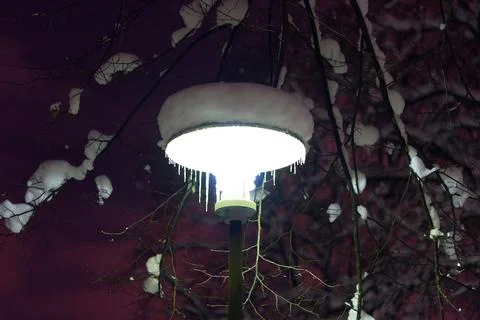 Street lamp in the night under the snow in winter time. Stock Photos