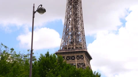 Street lantern, trees in late spring and the Eiffel Tower in Paris, France Stock Footage 260695738