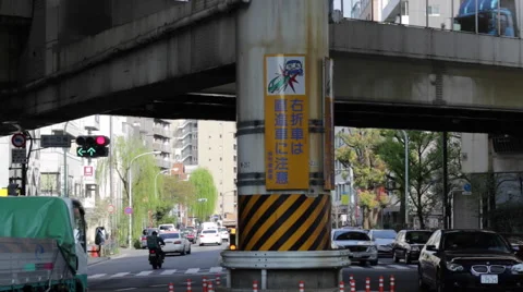 Street level busy Tokyo intersection and accident warning sign Stock Footage 49605743
