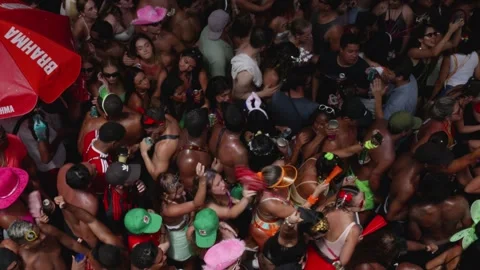 Street-level pan left reveals exuberant dancers at Rio de Janeiro Carnaval Stock Footage 312773515