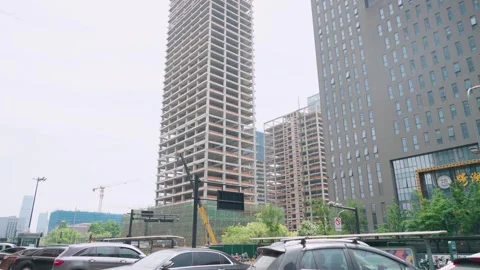 Street level view of high-rise construction site in Hangzhou, China, showing Видео 335355448