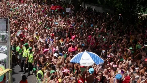 Street-level view shows exuberant dancers waving and cheering in Rio's Carnaval Stock Footage 312783972