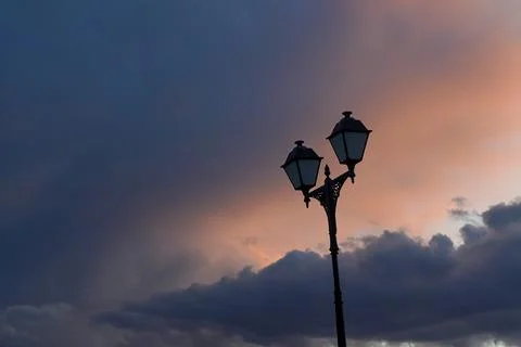 Street light against dramatic sunset sky after rain Stock Photos