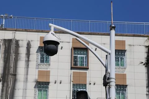 A street light with a camera on top of it Stock Photos