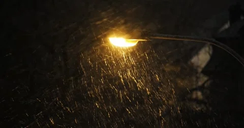 Street light illuminating falling snow during snowstorm at night Video stock 327267685