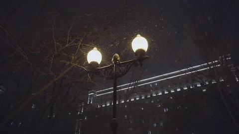 Street light pole at blizzard on the background of the building at winter night 스톡 동영상 103916944