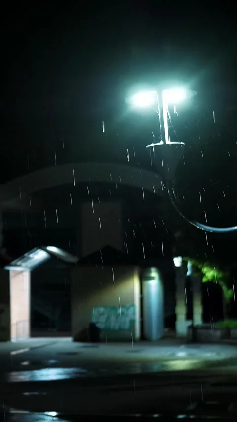 Street light. Rain Drop.Rain in the night. Light rainfall. Puddle with lights Stock Footage 315439042