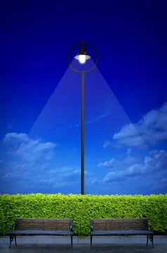 Street lighting with two bench and shrub Foto stock