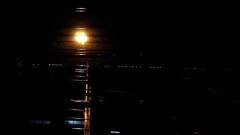 The street lights at night make the drops on the wires lined. Stock Footage 77743001