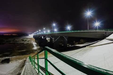 Street lights reflected on the water surface and night landscape Stock Photos