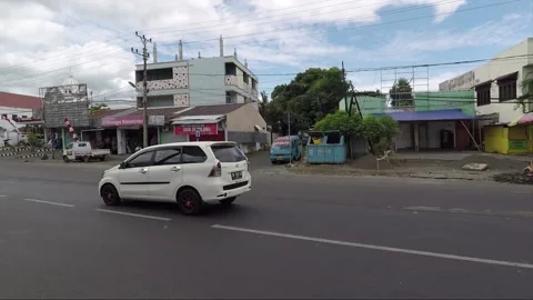 Street in Manado, Sulawesi, camera slide, car and bike passing by Stock Footage 144542353