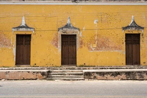 Street in Muna, Yucatan, Mexico with yellow wall and doors Stock Photos