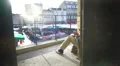 Street musician playing drums on balcony of the old house, urban life, poverty HD Footage