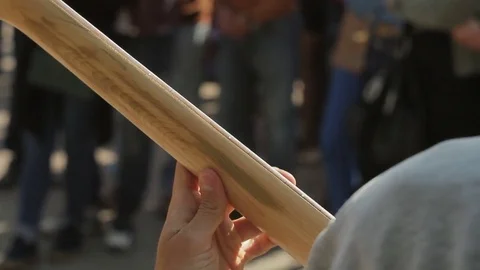 The street musician plays the bass guitar for the spectators, the view from the Stock Footage