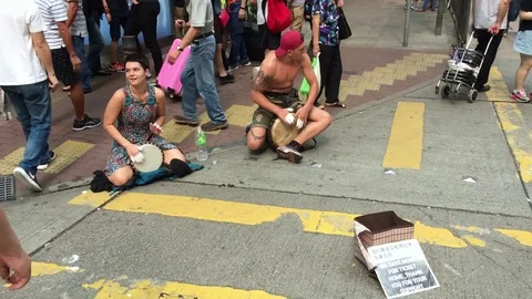 Street musicians play on drums in Hong Kong Stock Footage