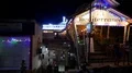 Street night scenery illuminated restaurant front with people in Labuan Bajo 4k or 4k+ Resolution