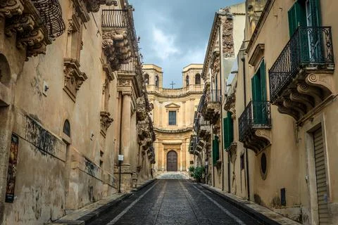 Street in old part of Noto city, Sicily in Italy, view with Montevergine Church Stock Photos
