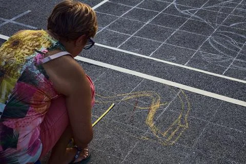Street painters at a convention while drawing sacred pictures on the asphalt  Stock Photos