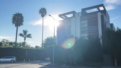 Street with palm trees camera comes out from under a building  Stock Footage 169341091