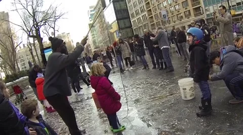 Street performer creates bubble over child Stock Footage 48368548