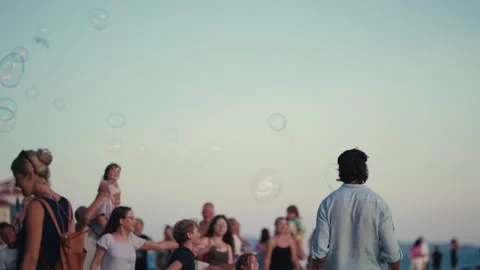 Street Performer Creating Giant Soap Bubble for Crowd Stock Footage 340324160