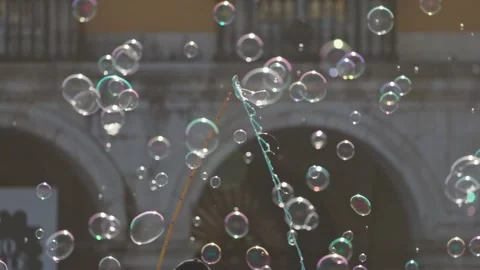 Street performer creating large soap bubbles in plaza Stock Footage 305897445