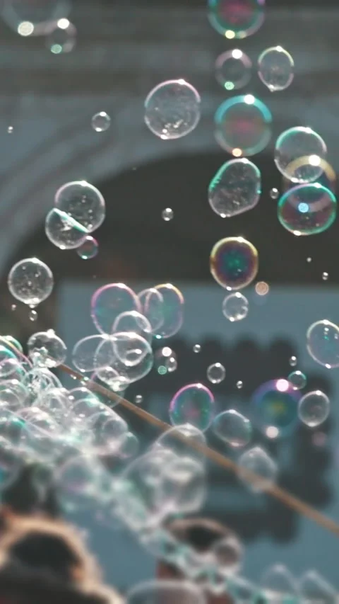Street performer creating large soap bubbles for a crowd Stock Footage 327449483