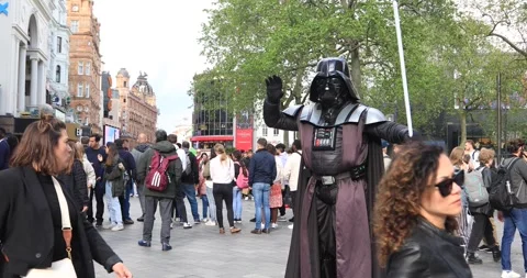 Street performer as Darth Vader posing among crowds in London square Stock Footage 321016448