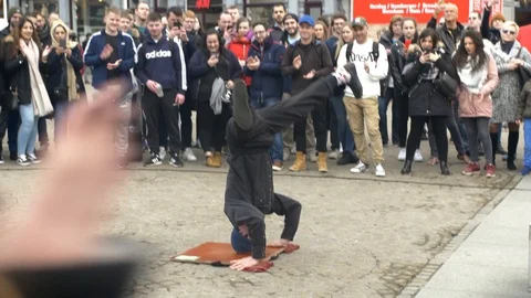 Street performer doing a headspin. Stock Footage 105873681