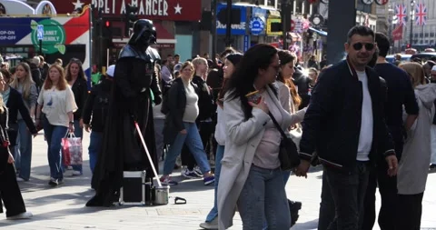 Street performer dressed as Darth Vader entertaining London pedestrians Stock Footage 321016472