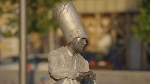 Street performer dressed as silver statue Stock Footage 100367438